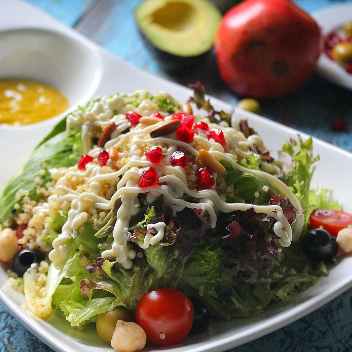 Vibrant quinoa salad with fresh vegetables, avocado, and pomegranate seeds